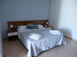 Posteľ alebo postele v izbe v ubytovaní Grand Hostel Calabria