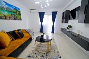 a living room with a couch and a table at FLH - Just 5 in Şelimbăr