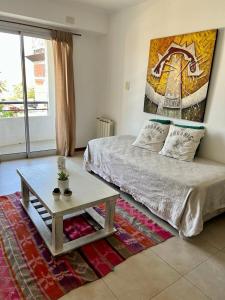 a bedroom with a bed and a coffee table at Departamento tranquilo completamente equipado in Salta