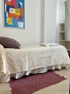 a bedroom with a bed with a painting on the wall at Departamento tranquilo completamente equipado in Salta