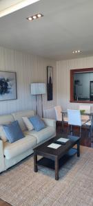a living room with two couches and a coffee table at Acogedor apartamento con terraza en Portonovo in Portonovo