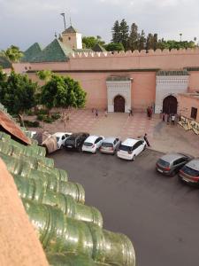 a group of cars parked in front of a building at Peace Hotel in Marrakesh