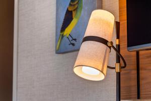 a lamp with a paper towel hanging on a wall at Cambria Hotel Columbia Downtown the Vista in Columbia
