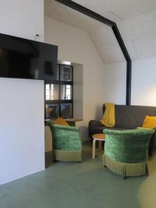 a living room with a couch and a tv at Ferieidyl in Kettinge