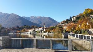 a town by a river with mountains in the background at COSY LITTLE HOME in Mergozzo