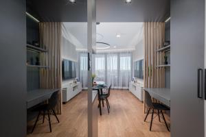 a kitchen with a table and a dining room at Apartament Mateo Inn in Kraków