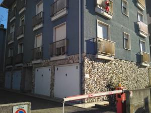 a blue building with two garage doors and a fire hydrant at Grande appartamento in Centro, 4 posti letto in Gorizia