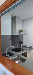 a kitchen with a sink and a counter top at Acogedor apartamento con terraza en Portonovo in Portonovo