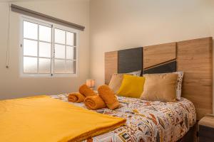 een slaapkamer met een bed met twee knuffels erop bij CASA POR DO SOL in Calheta