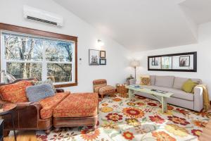 a living room with a couch and a table at The Beautiful Bears Den! Walk to Old Town and CSU! in Fort Collins