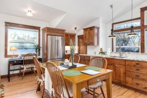 a kitchen with a wooden table and wooden chairs at The Beautiful Bears Den! Walk to Old Town and CSU! in Fort Collins +21 photos