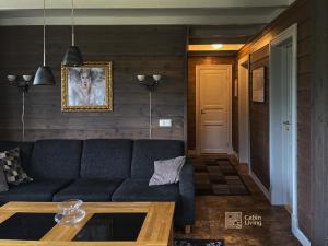 a living room with a couch and a table at Great apartment in Trysil, ski inout, wifi, sauna in Trysil