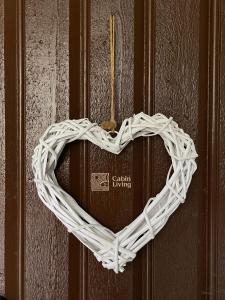 a heart shaped wicker heart hanging on a door at Great apartment in Trysil, ski inout, wifi, sauna in Trysil