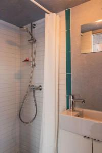 a bathroom with a shower and a sink at Beautiful Tiny house on the lake side. in Trakai