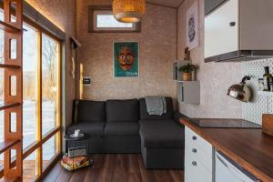 a living room with a couch in a tiny house at Beautiful Tiny house on the lake side. in Trakai