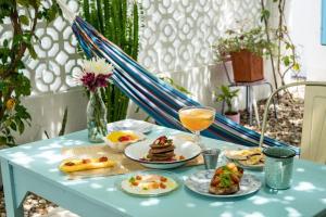 a table with plates of food and a glass of orange juice at Casa Celeste Honda in Honda