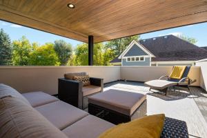 a screened in porch with a couch and chairs at Relaxing in Paradise with Private Rooftop Deck! in Fort Collins