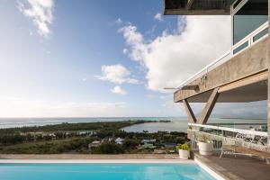 a view from the balcony of a house with a swimming pool at Villa Cambier by muse villas in Le Morne