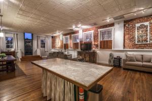 a living room with a large table in the middle at Elegant Loft-Style Retreat in Old Firehouse Alley in Fort Collins