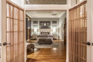 a bedroom with a bed and a large window at Elegant Loft-Style Retreat in Old Firehouse Alley in Fort Collins