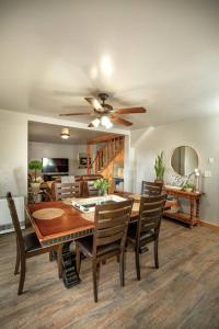 a dining room with a table and a ceiling fan at Afton Farmhouse with Mountain Views in Afton
