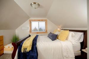 a bedroom with a bed and a window at Afton Farmhouse with Mountain Views in Afton