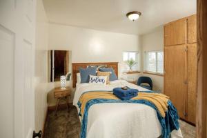 a bedroom with a large bed with blue pillows at Afton Farmhouse with Mountain Views in Afton