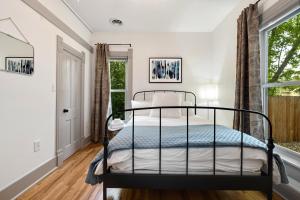 a bedroom with a bed and a window at Lola House! Cozy Comfort, Prime Old Town Location in Fort Collins