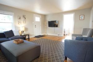 a living room with two couches and a tv at Beautiful Bungalow Next to UNC - Free Cruiser Bikes! in Greeley