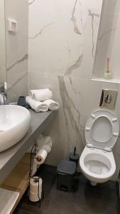 Łazienka z białą toaletą i umywalką w obiekcie Sun Center Eilat w Ejlat