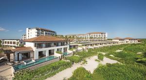 an aerial view of a resort with a pool at Secrets Playa Mujeres Golf & Spa Resort - All Inclusive Adults Only in Cancún