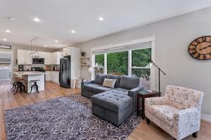 a living room with a couch and chairs and a kitchen at Cozy Chic Home In Downtown Loveland! in Loveland