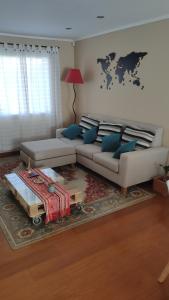 a living room with a couch and a table at Lo de Lucas in Olavarría