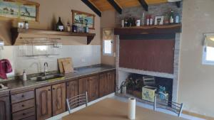 a kitchen with wooden cabinets and a sink at Lo de Lucas in Olavarría