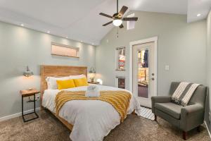 een slaapkamer met een bed en een stoel bij Vibrant Downtown Bungalow - Walk Everywhere! in Fort Collins