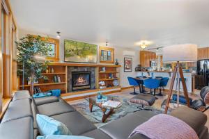 a living room with a couch and a fireplace at Sleek Condo - Near Park, Poudre River and Old Town in Fort Collins