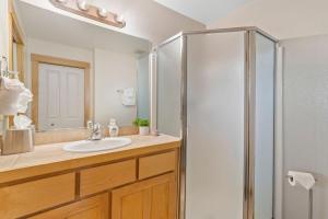 a bathroom with a sink and a shower at Sleek Condo - Near Park, Poudre River and Old Town in Fort Collins +31 photos