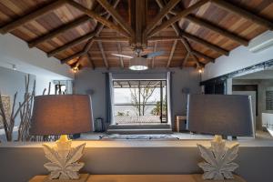 two lamps on a table in a room with a window at Koki Bonheur by muse villas in Poste Lafayette