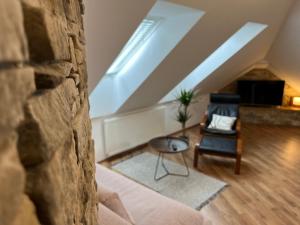 a living room with a couch and a chair at Rudolfquartier Linz, Rudolfstraße in Linz