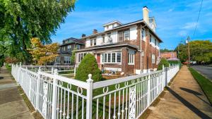 a white picket fence in front of a house at Allentown White House in Allentown