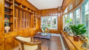 a dining room with wooden walls and a table and chairs at Allentown White House in Allentown