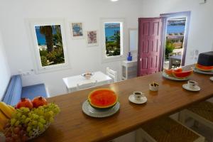 a kitchen with a table with fruit on it at Playera Bungalow G sea view in Naousa +39 photos