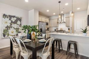 a kitchen and dining room with a table and chairs at Modern Farmhouse Townhome - Great Central Location in Fort Collins