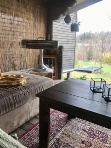 a living room with a table and a fireplace at 15 min från Ullared! Ny stuga med hög standard! in Älvsered