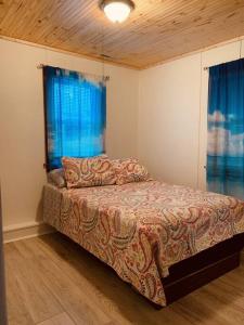 a bedroom with a bed and a window at Lakefront Cottage w/ Private Beach- Niagara 