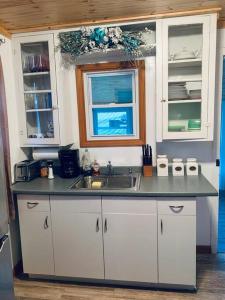 a kitchen with a sink and a window at Lakefront Cottage w/ Private Beach- Niagara in Ransomville