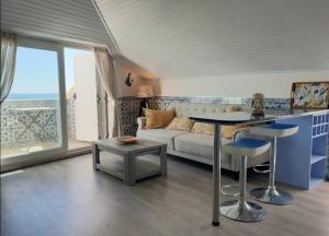 ein Wohnzimmer mit einem Sofa und einem Tisch in der Unterkunft BLUE HOUSE SESIMBRA with parking in Sesimbra