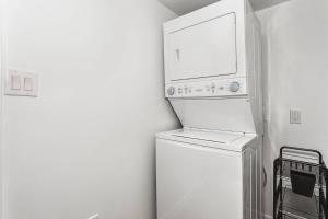 a white refrigerator with a microwave on top of it at Peach's Place in Pensacola