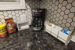 a kitchen counter with a coffee maker on it at Retreat Suite 1 - Cozy Downtown Getaway in Grand Rapids