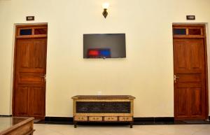 a room with two doors and a tv on the wall at Minara Miwili - Forodhani Park in Zanzibar City